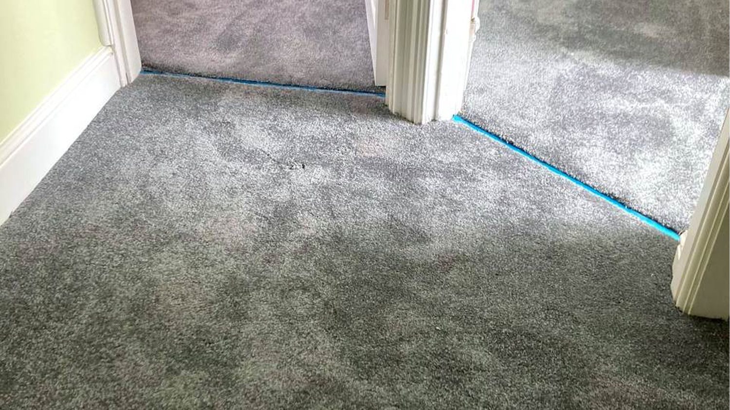 Grey carpet fitted across a landing and cut in neatly at two doorways